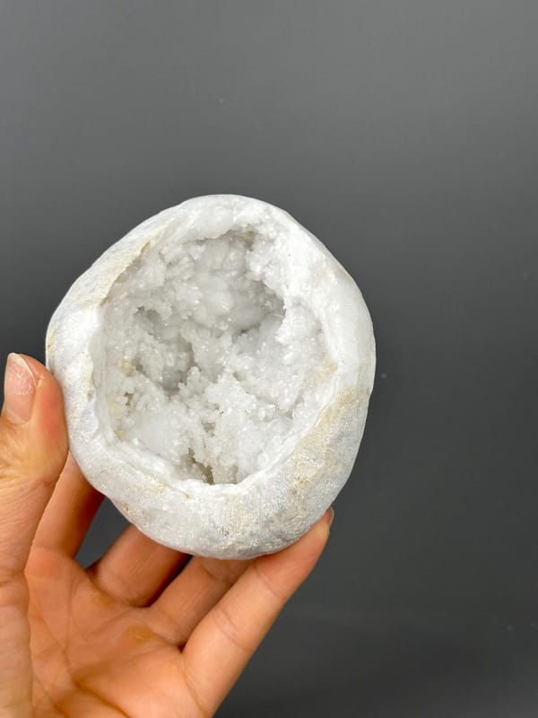 Top opening of large quartz geode on gold base