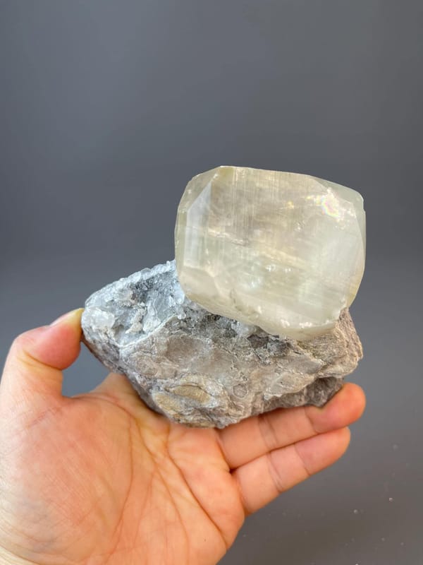 Yellow calcite sphere with radiating crystal blades on matrix