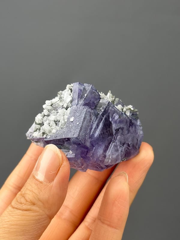 Front view of deep purple twinned fluorite with calcite