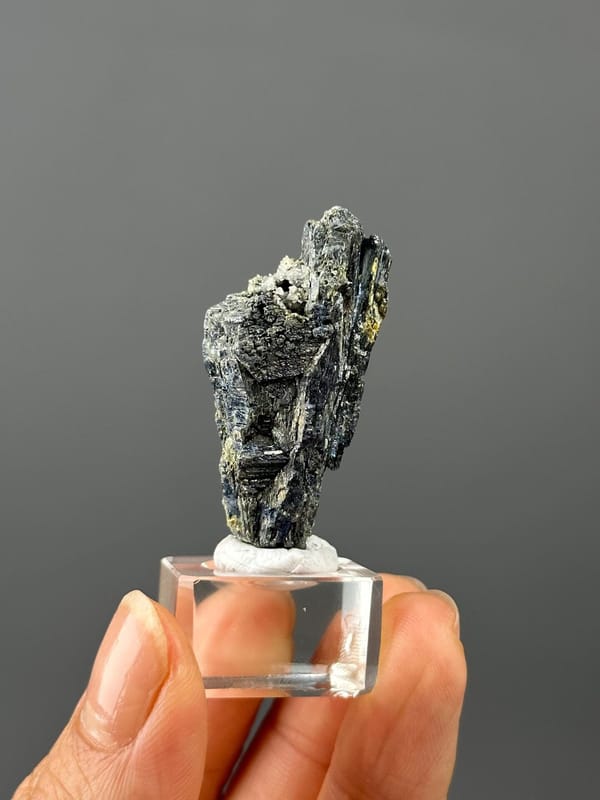 Close-up of stibnite surface showing iridescent metallic sheen
