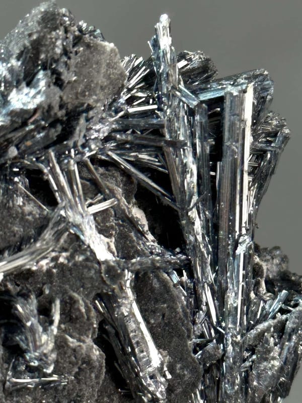 Angled view of metallic stibnite blade cluster