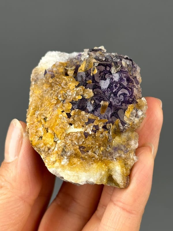 Vitreous luster on purple fluorite and gold calcite