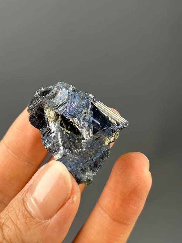 Full stibnite specimen on white background