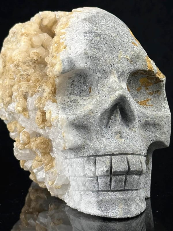 Extra-large hand-carved quartz geode skull with druzy crystal interior