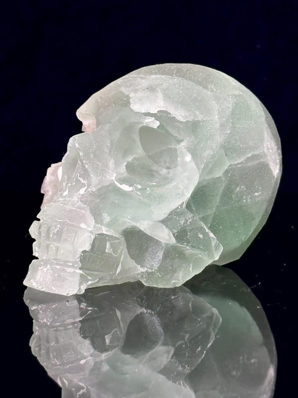 Detail of raw fluorite geode within carved skull
