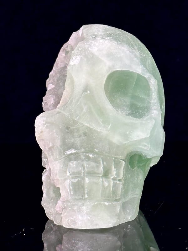 Front view of green fluorite skull showing carving detail