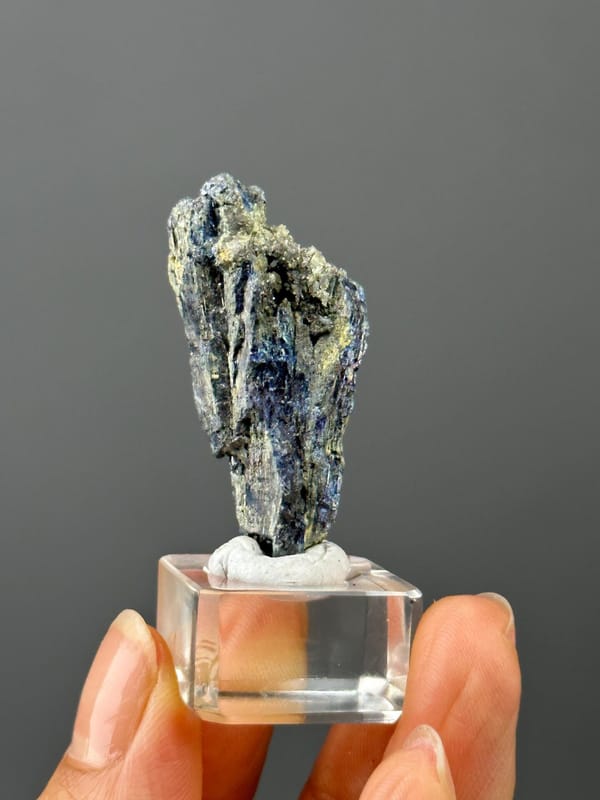 Front view of iridescent stibnite crystal, 1.8×0.6×0.7 in