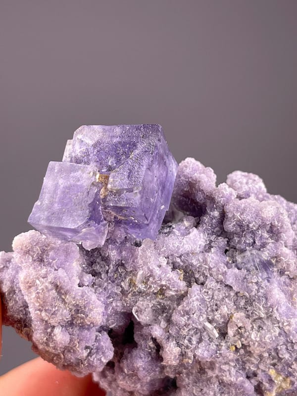 Purple CaF₂ fluorite cluster with silver mica blades