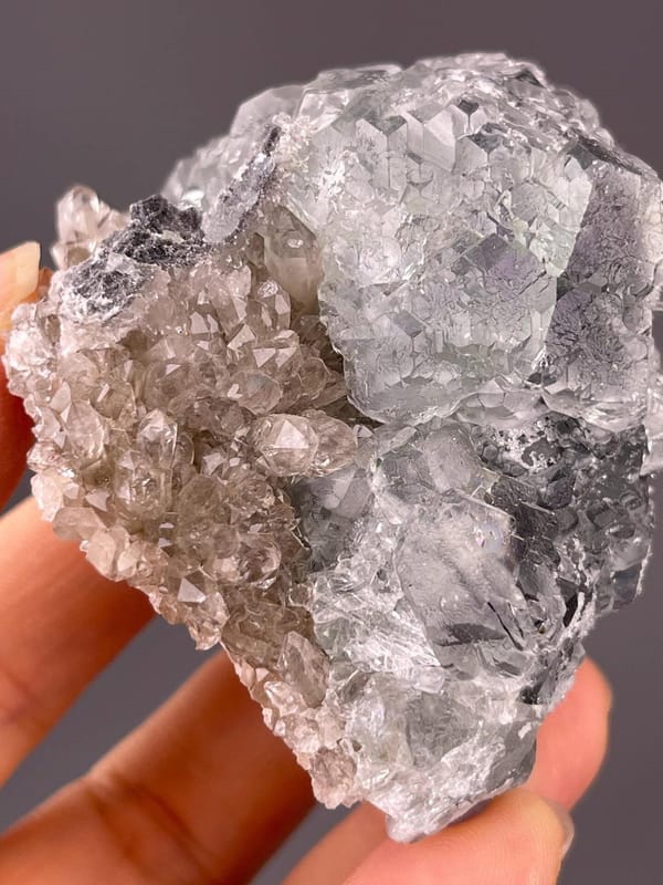 Translucent green fluorite spheres on crystalline quartz base
