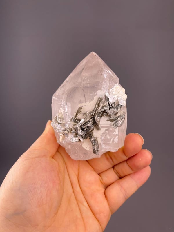 Clear quartz with silver-white mica blades and rosette forms
