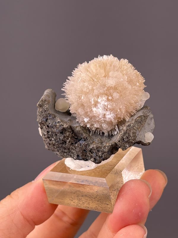 Back view of Indian stilbite sphere on basalt