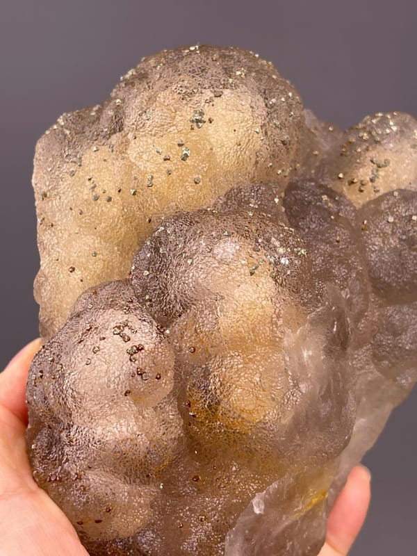 Close-up of pyrite crystals on yellow fluorite matrix