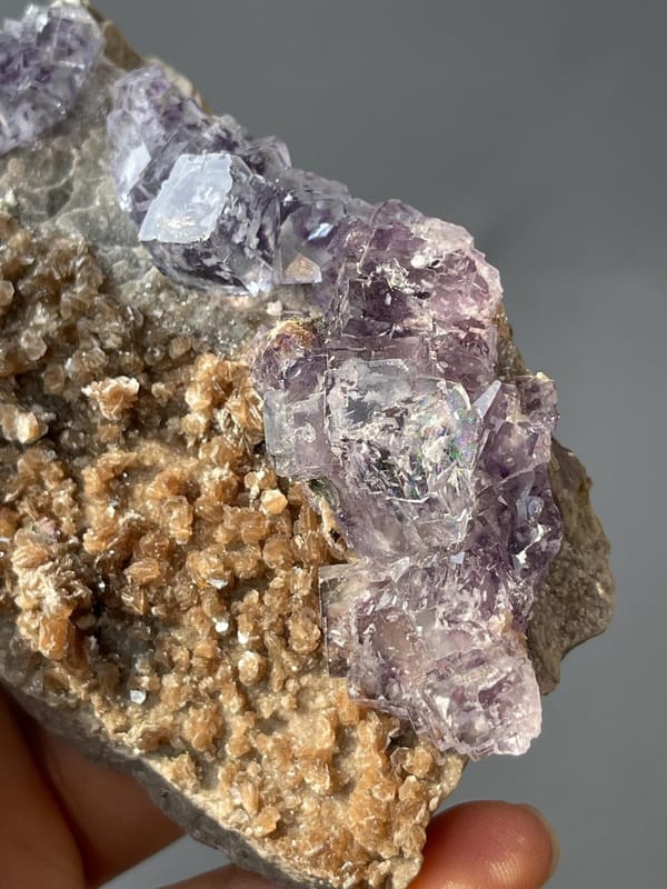 Twinned phantom fluorite crystals on lustrous mica base