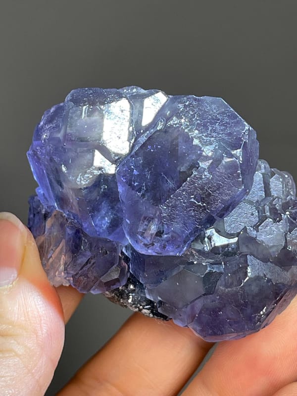 Purple-green phantom fluorite cluster displaying vitreous luster