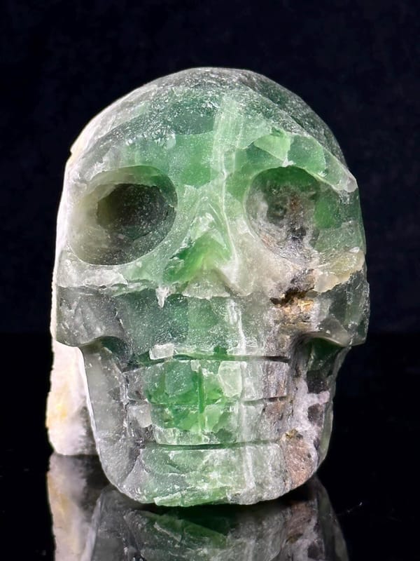 CaF₂ isometric fluorite carved into skull form with hollow geode
