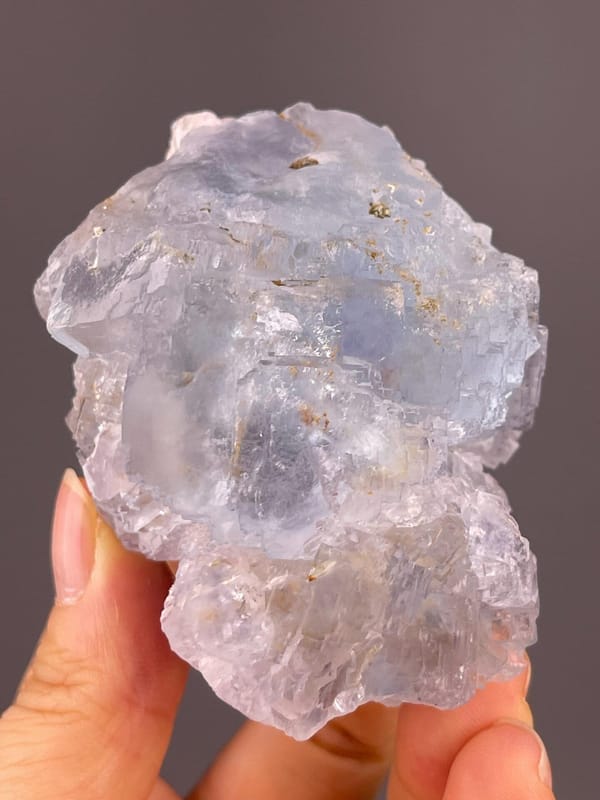 Icy blue fluorite with translucent cubic crystal habit