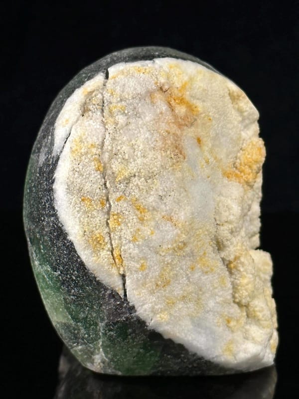 Artisan-carved fluorite skull with natural coloration and geode