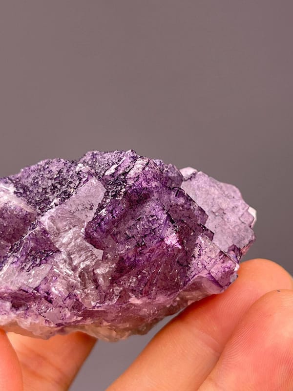 Textured purple fluorite specimen with dimensional crystal surface