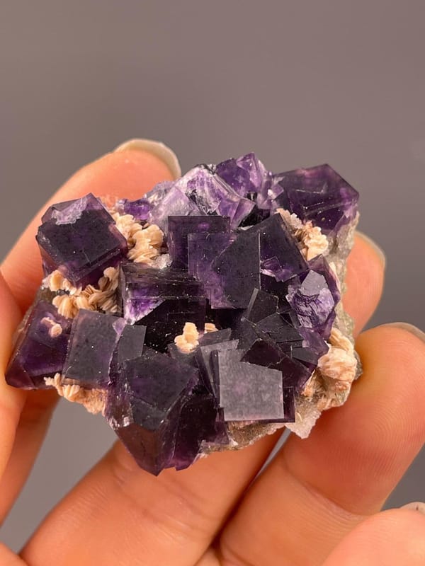 Purple fluorite cubic crystal habit on calcite