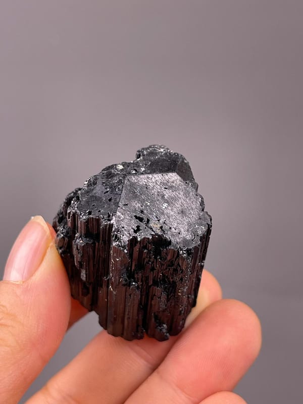 Vertical striations on black tourmaline crystal faces