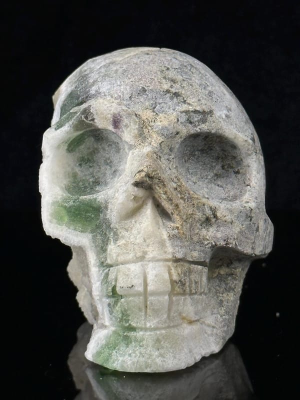 Raw mineral matrix on reverse of green fluorite skull