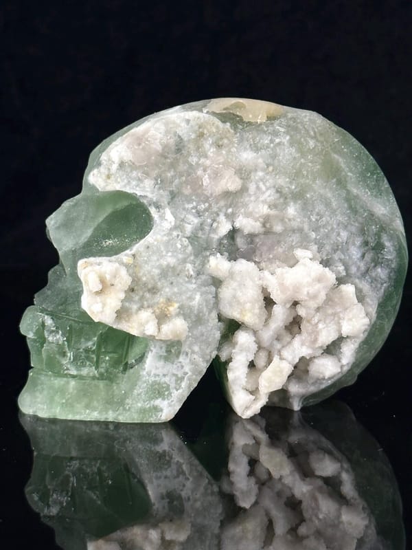 Side profile of green fluorite skull showing geode opening