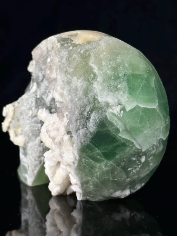 Green and white fluorite banding on carved skull face