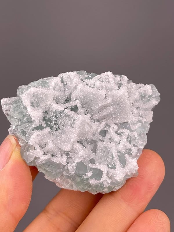 Side view of fluorite with druzy quartz overgrowth