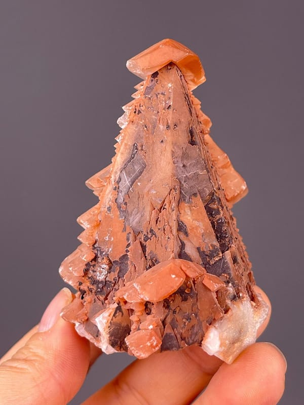 Close-up of calcite scalenohedral faces with red coloration