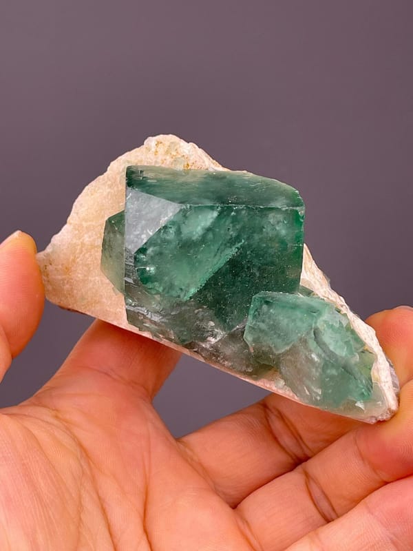 Daylight-reactive green fluorite cube from Madagascar