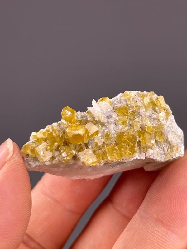 Angled view of yellow fluorite cubic cluster specimen
