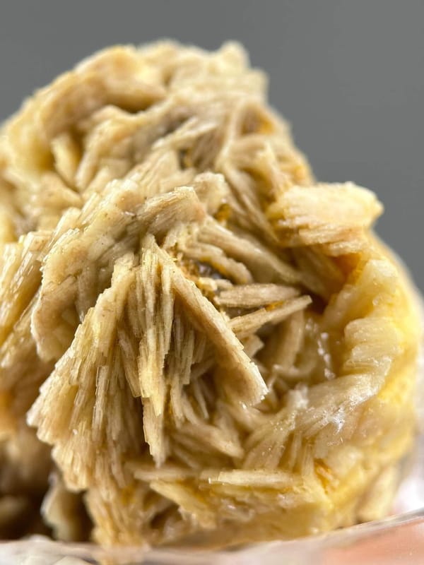 Crystal faces of golden barite showing vitreous luster