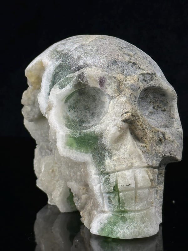 Close-up of polished green fluorite skull face