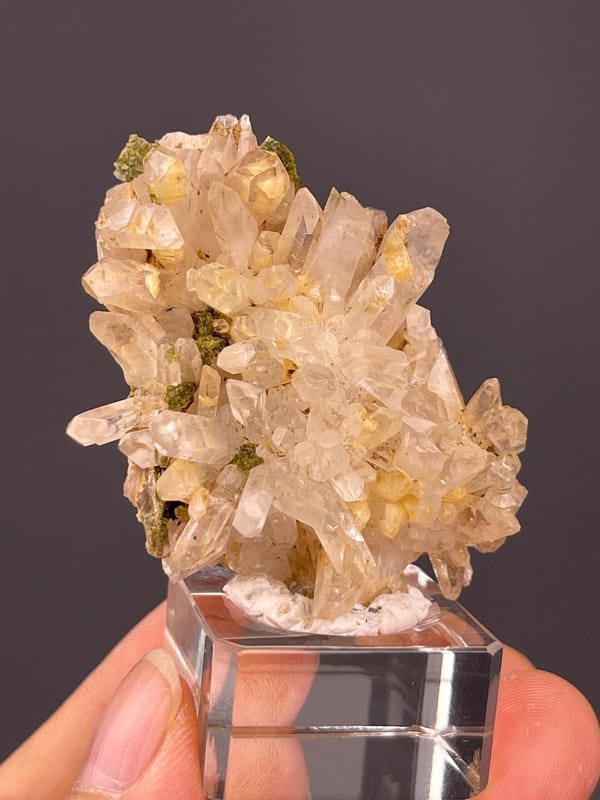 Front view of garden quartz cluster with epidote inclusions