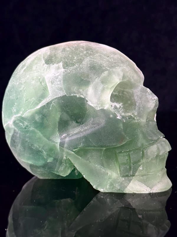 Three-quarter angle of green fluorite skull carving