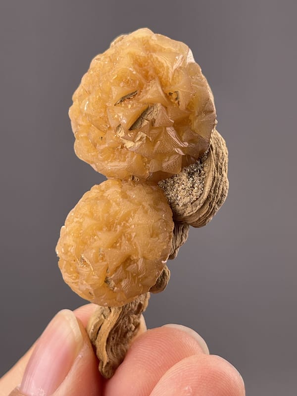 Close-up of calcite botryoids showing orange-gold coloration