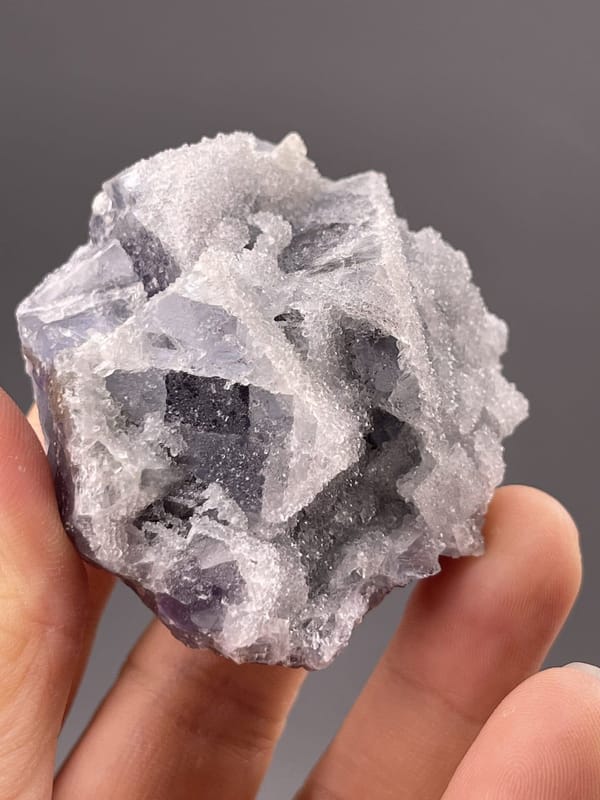 Close-up of purple fluorite cubic faces showing vitreous surfaces