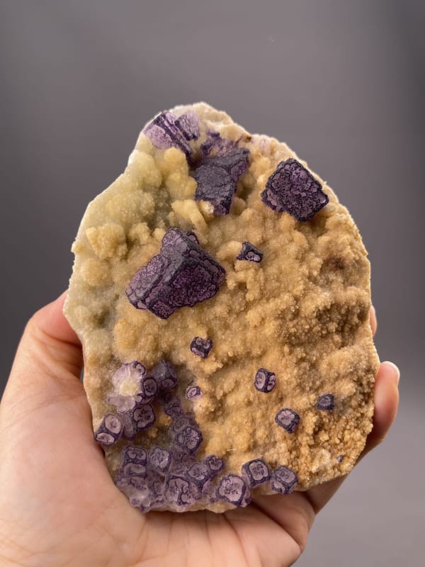 Angled view of Guizhou fluorite cube highlighting deep colour