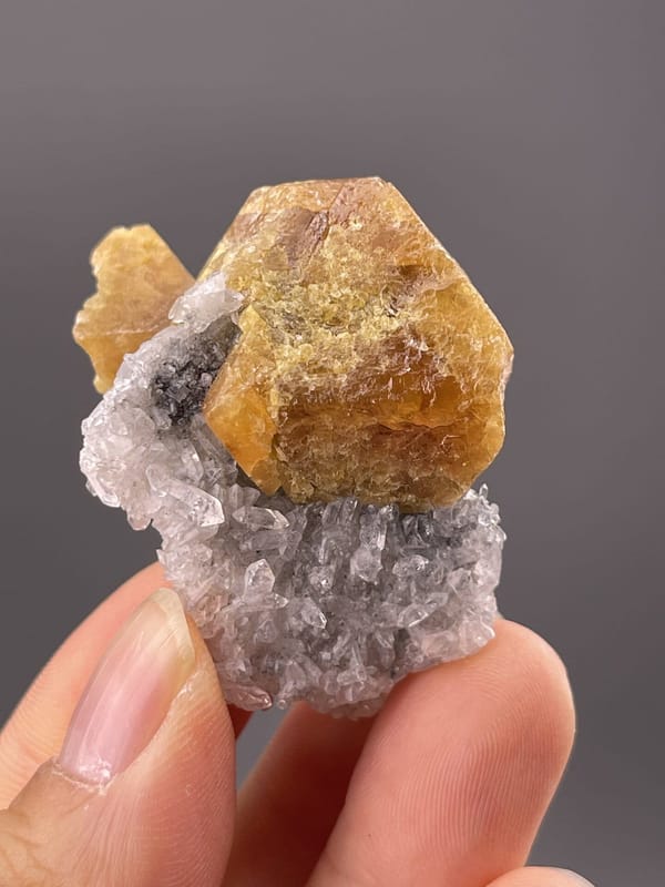 Angled view of Xuebaoding scheelite highlighting honey-yellow colour