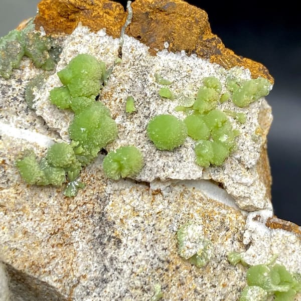 Apple-green pyromorphite balls on pale sandstone plate from Guangxi, China, view 2 of 9