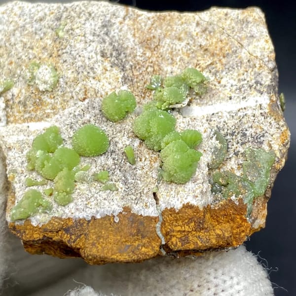 Apple-green pyromorphite balls on pale sandstone plate from Guangxi, China, view 5 of 9