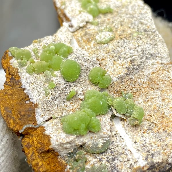 Apple-green pyromorphite balls on pale sandstone plate from Guangxi, China, view 6 of 9