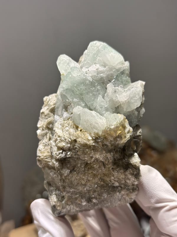 Mica block with pale green aquamarine crystals from Xuebaoding, Sichuan, China, close-up of the crystal faces