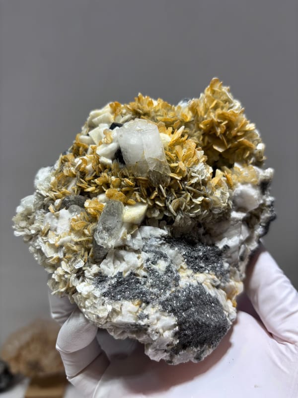 Golden mica and aquamarine cluster with cassiterite and quartz from Xuebaoding, Sichuan, China, close-up of the crystal faces