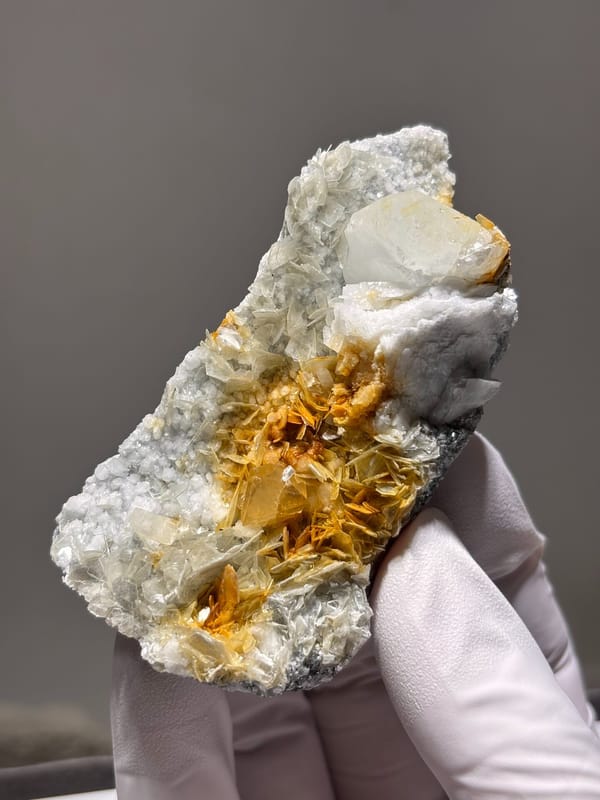 White feldspar plate with aquamarine, orange scheelite and mica from Xuebaoding, Sichuan, China, second angle