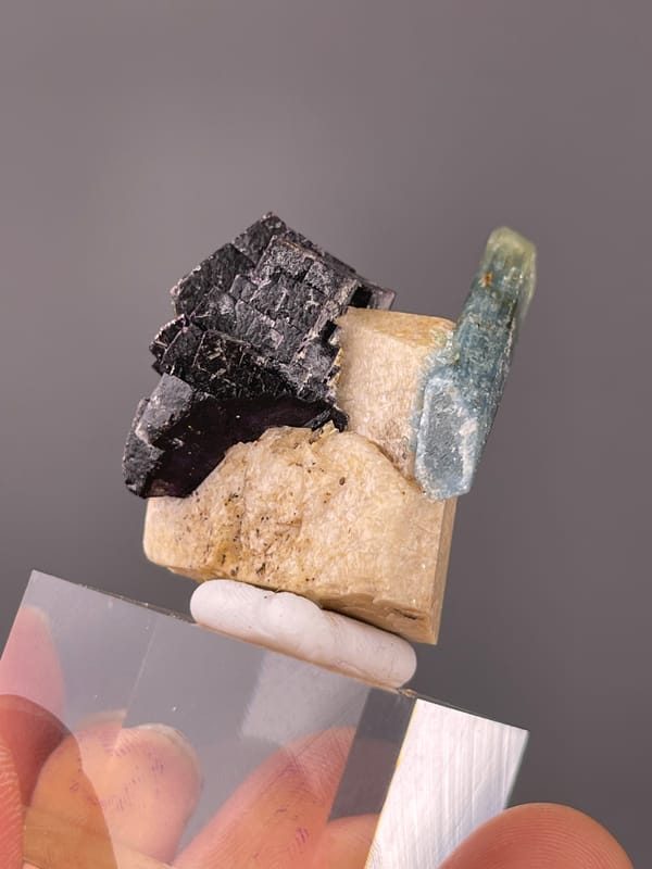 Pale-blue beryl crossing black schorl seen across this aquamarine specimen