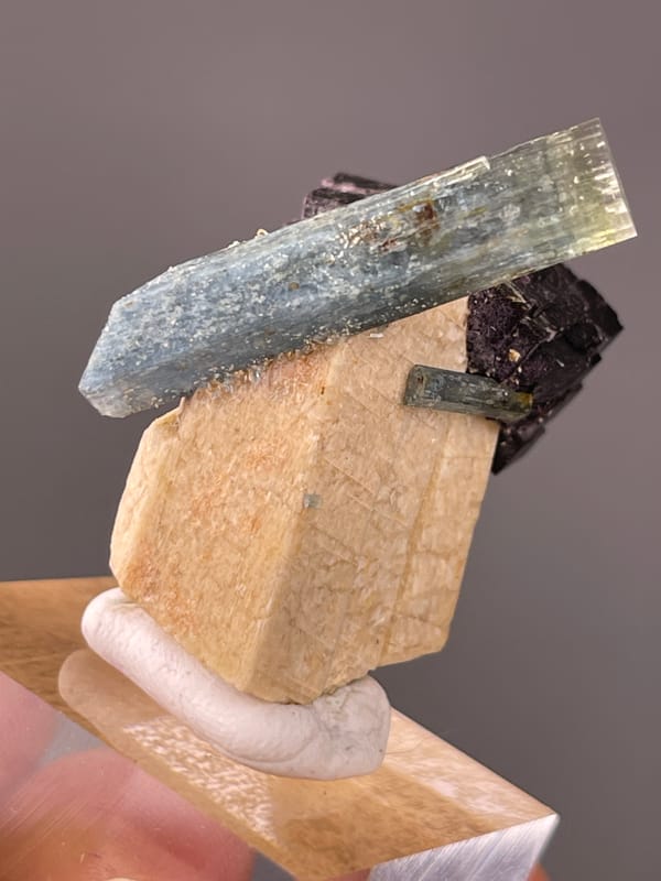 Aquamarine specimen characterized by pale-blue beryl crossing black schorl visibly