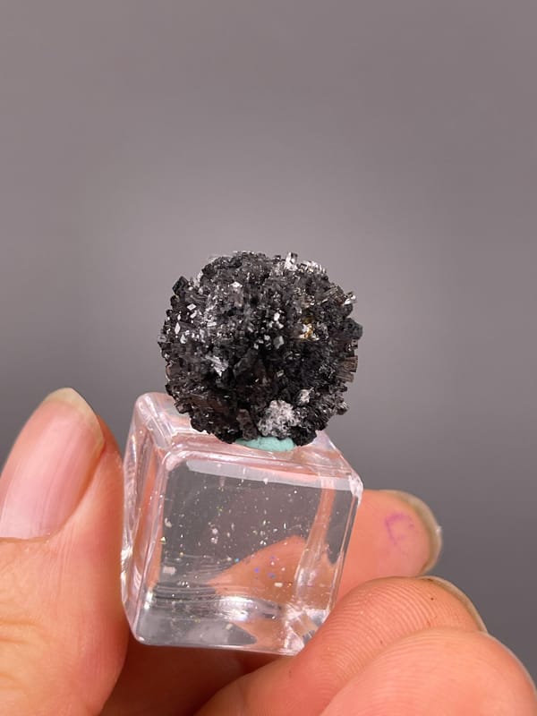 Black spherical radiating aggregate on natural aurora calcite specimen from Longyan, Fujian, China