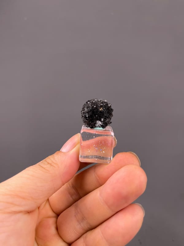 Aurora Calcite specimen from Longyan, Fujian, China bearing black spherical radiating aggregate