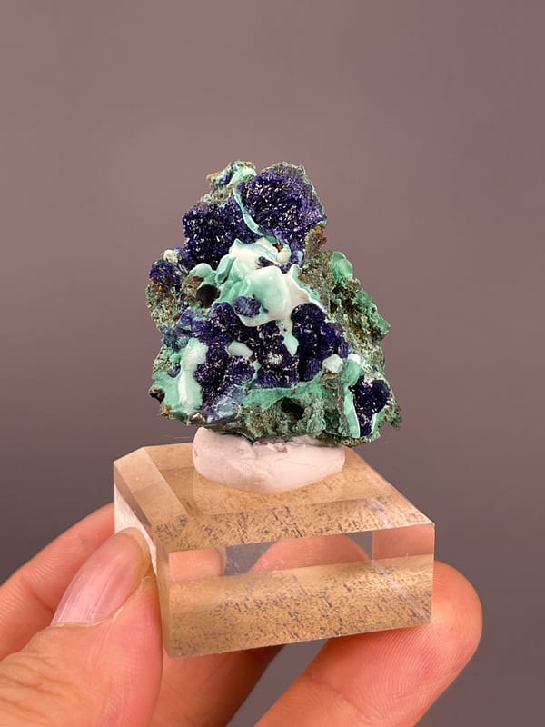 Azurite from Anhui, China: upright blue-and-green specimen on display base.